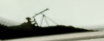 Person using a telescope printed in the black window edge of the Avenger, on the lower passenger side.